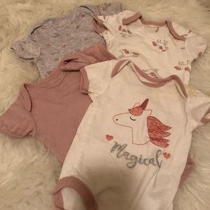 Four piece set of Unicorn Onesies by René Rofé